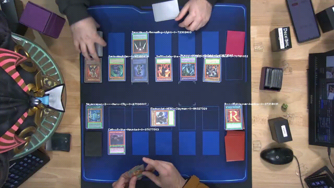 DRAW2 detecting and naming Yu-Gi-Oh! cards live on a dueling mat, overlaying bounding boxes and card names in real time